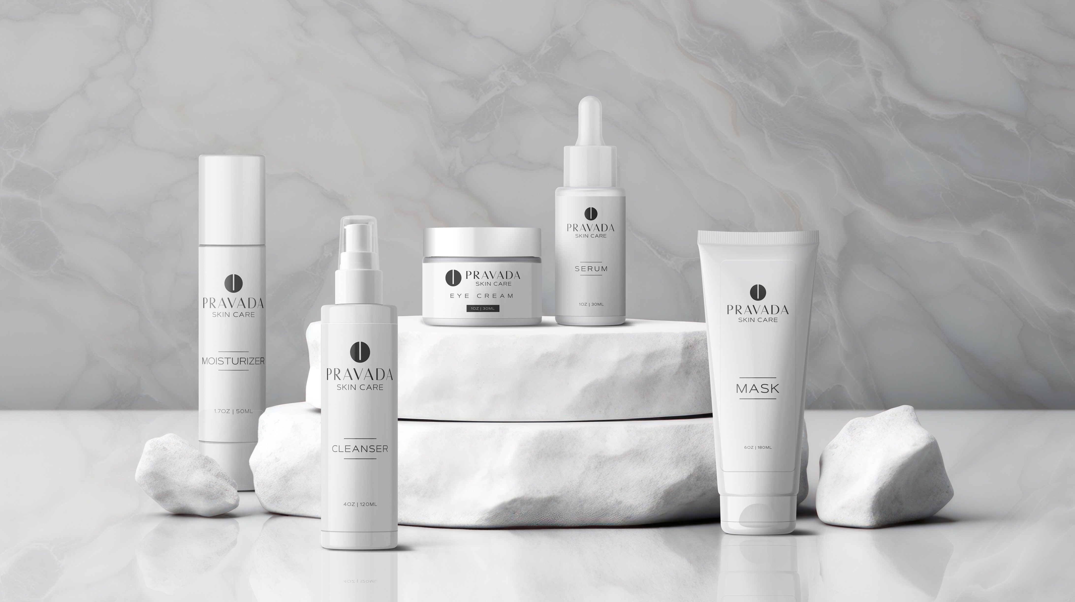 Elegant mockup display of Pravada's private label skincare products, featuring a cleanser, moisturizer, serum, eye cream, and mask on a marble background. High-quality skincare solutions for private label branding.